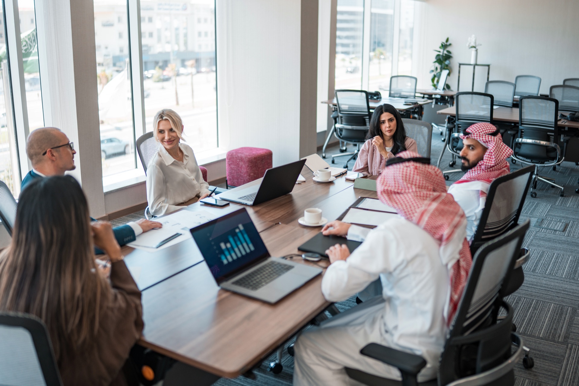 Multicultural executive team in a Saudi boardroom — restructuring and turnaround advisory