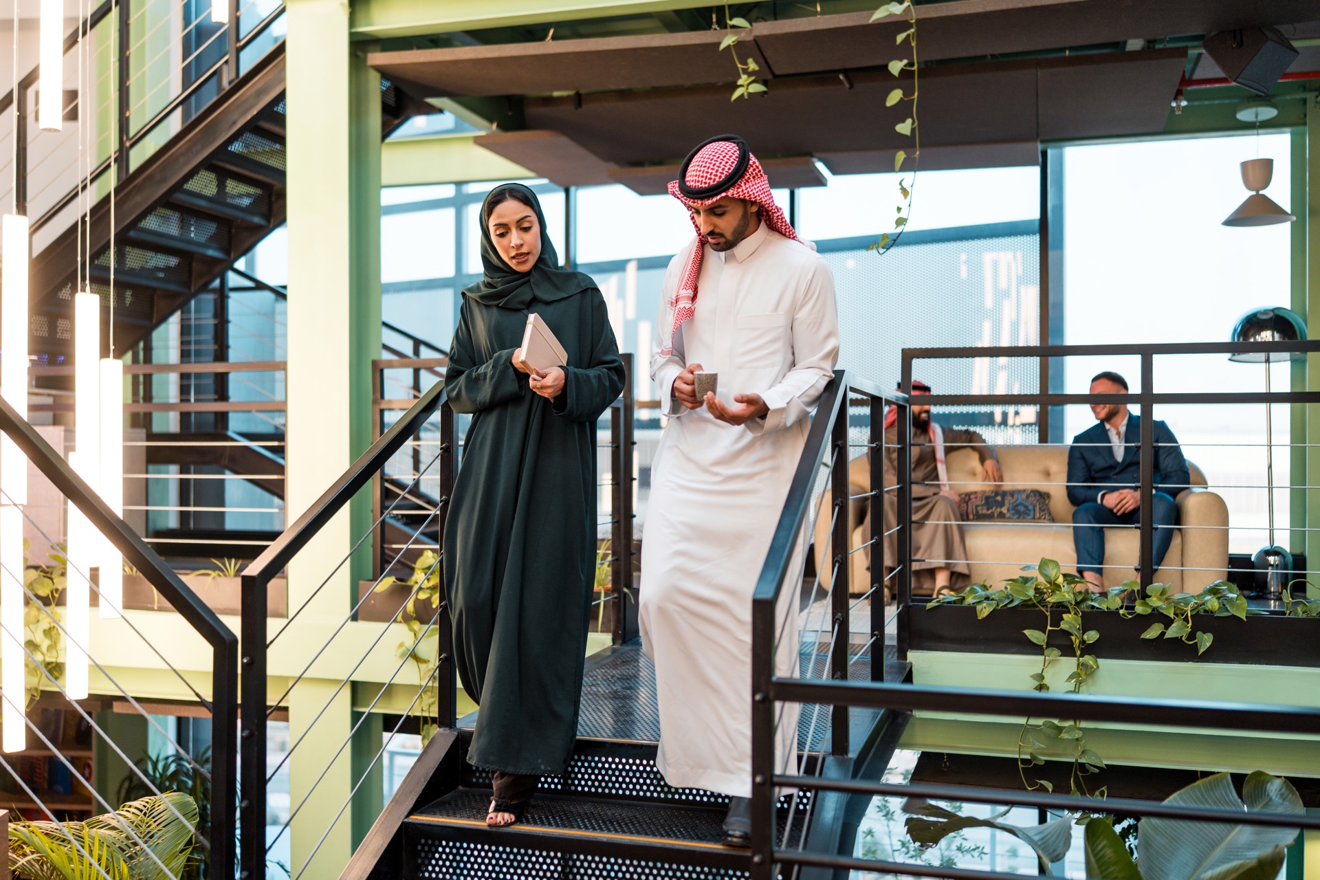 Saudi finance professionals in a modern Riyadh office
