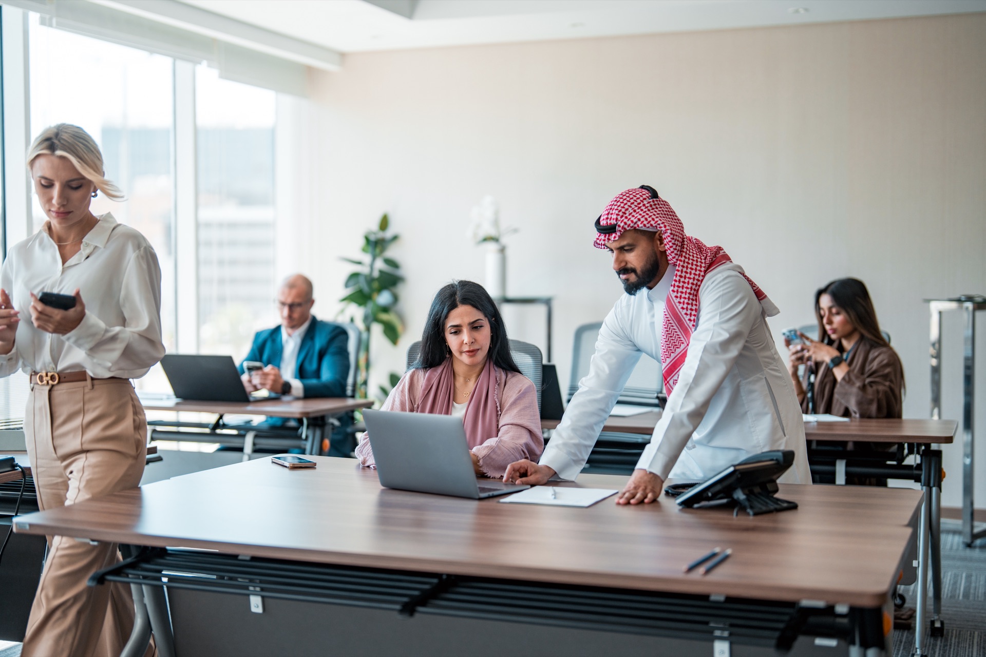 Saudi and international professionals collaborating in a Riyadh office