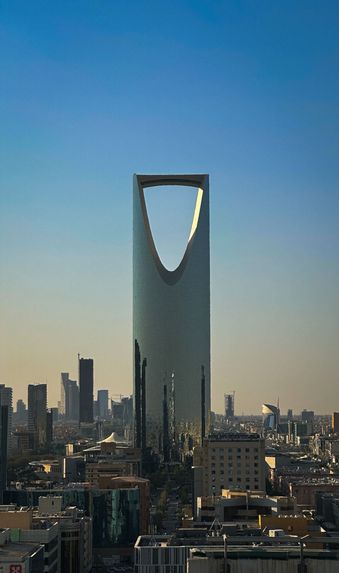 Kingdom Centre tower rising above the Riyadh skyline — symbol of Vision 2030