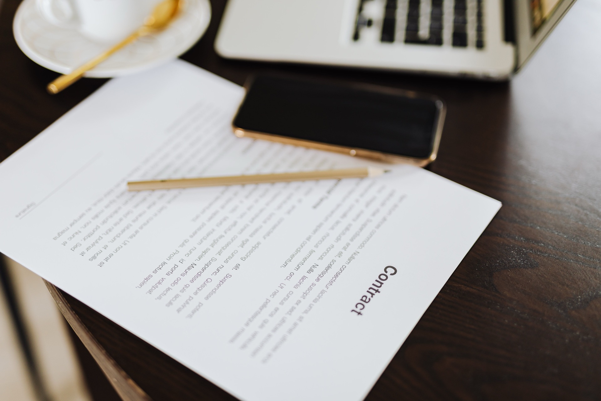 M&A advisory contract on desk with gold pen